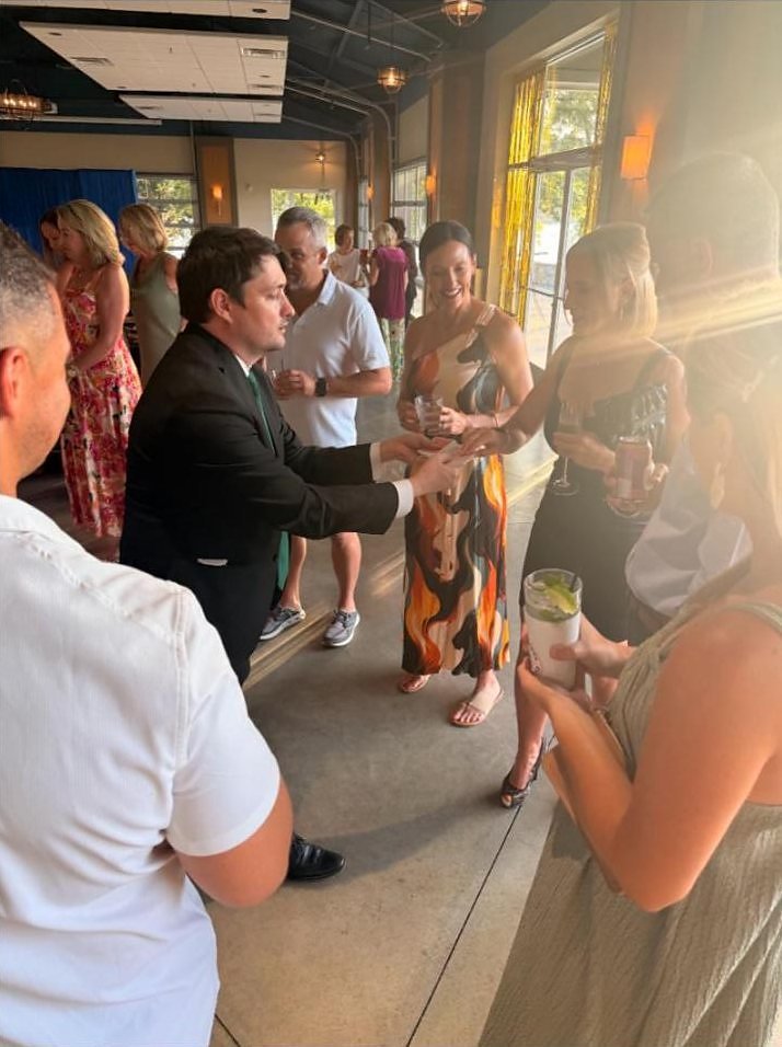Josh Weidner performing close-up magic for Cedar Creek Yacht Club members during cocktail hour.