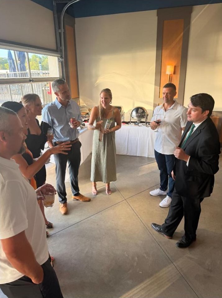 Josh Weidner with a group of Cedar Creek Yacht Club members at a cocktail table.