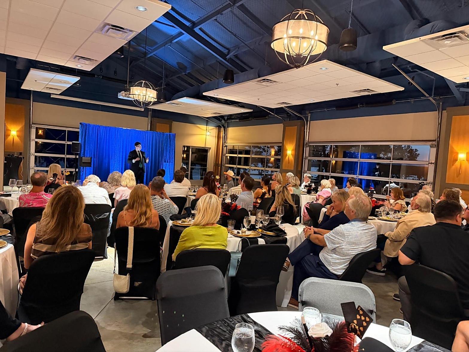 Josh Weidner performing a comedy magic show for eighty seated members at the Cedar Creek Yacht Club Supper Club.