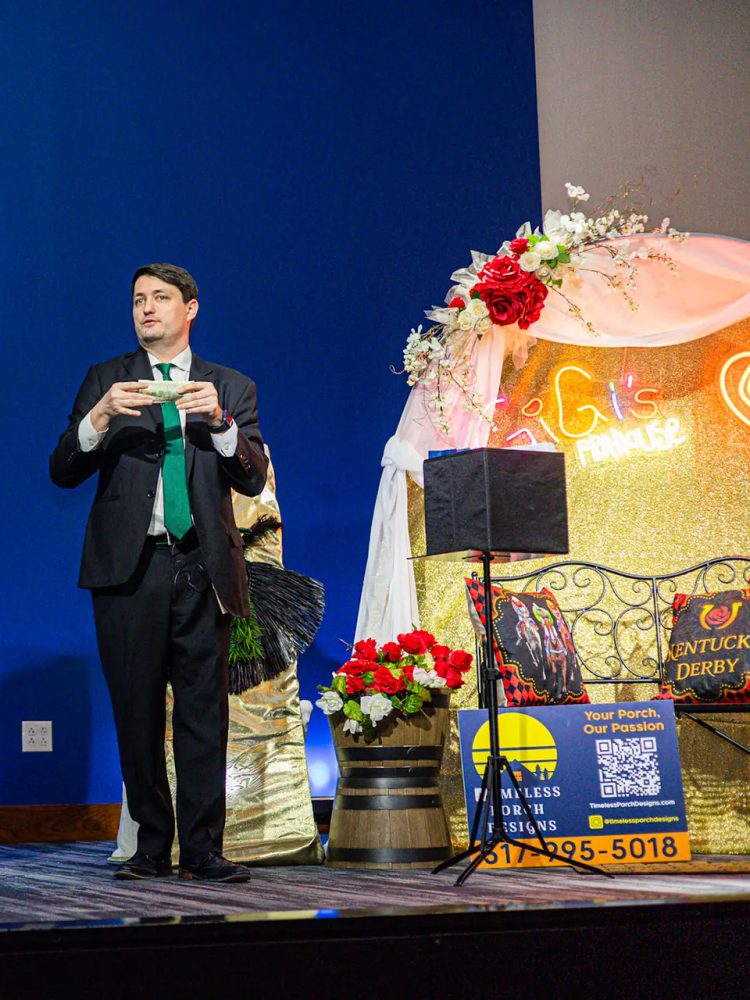 Josh Weidner performing the stage set beside the GiGi's Playhouse sign at the Indy gala.