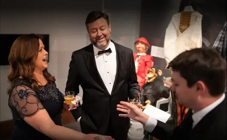 Holiday party magician Josh Weidner performing strolling magic during a drinks reception