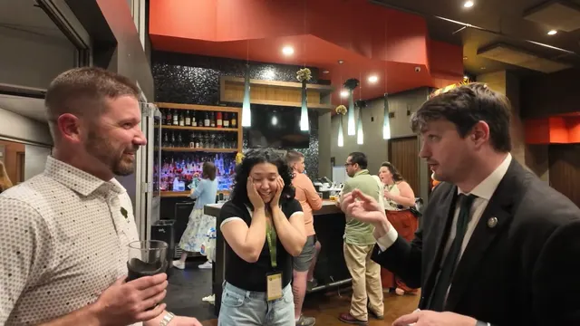 Guests reacting to close-up strolling magic at a company event