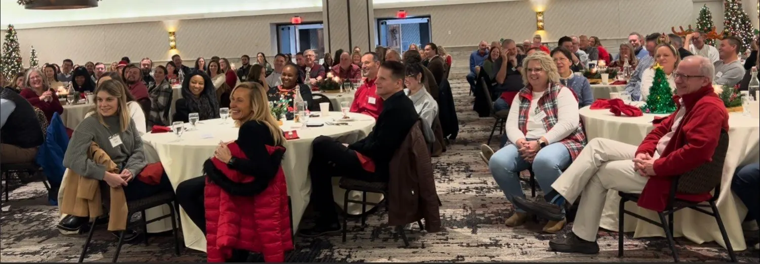 A company team laughing together during an interactive show by teambuilding magician Josh Weidner